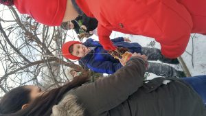 Children hanging birdfeeders